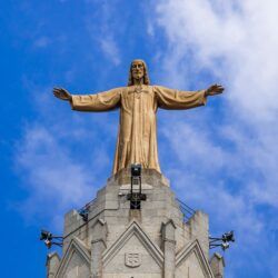 gold statue under blue sky